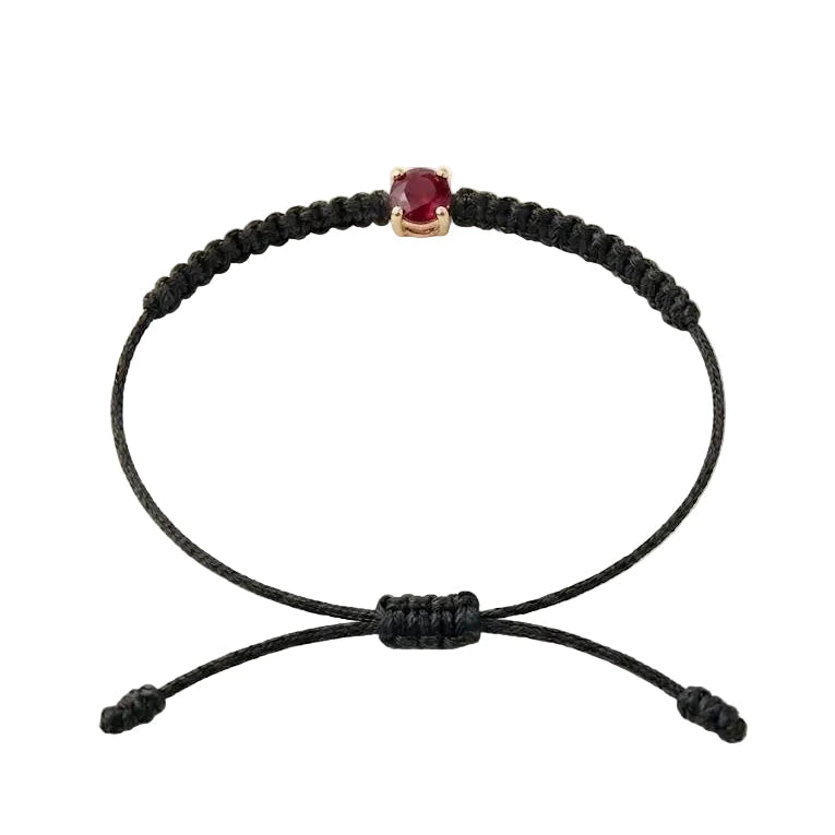 Bracelet cordon noir, pierre de rubis rouge de laboratoire sertie sur or 750/1000,
fermoir coulissant réglable
