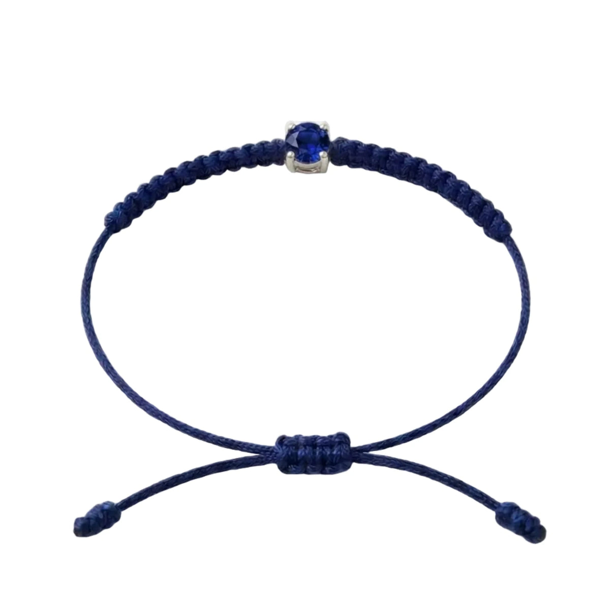 Bracelet cordon bleu marine, pierre de saphir bleu de laboratoire sertie sur or
750/1000, fermoir coulissant réglable
