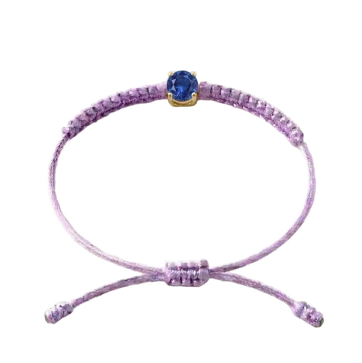 Bracelet cordon lilas, pierre de saphir bleu de laboratoire sertie sur or 750/1000,
fermoir coulissant réglable
