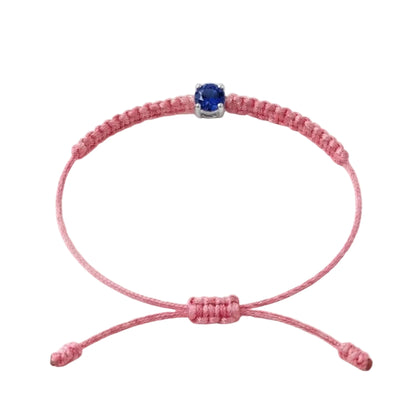 Bracelet cordon rose, pierre de saphir bleu de laboratoire sertie sur or 750/1000,
fermoir coulissant réglable
