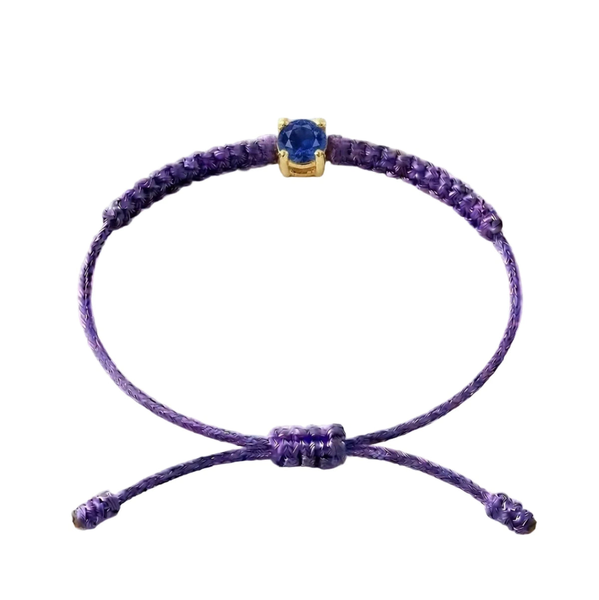 Bracelet cordon violet, pierre de saphir bleu de laboratoire sertie sur or
750/1000, fermoir coulissant réglable