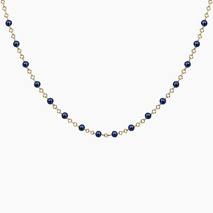 Collier chaîne fine en acier inoxydable dorée avec petites perles de résine colorées bleues